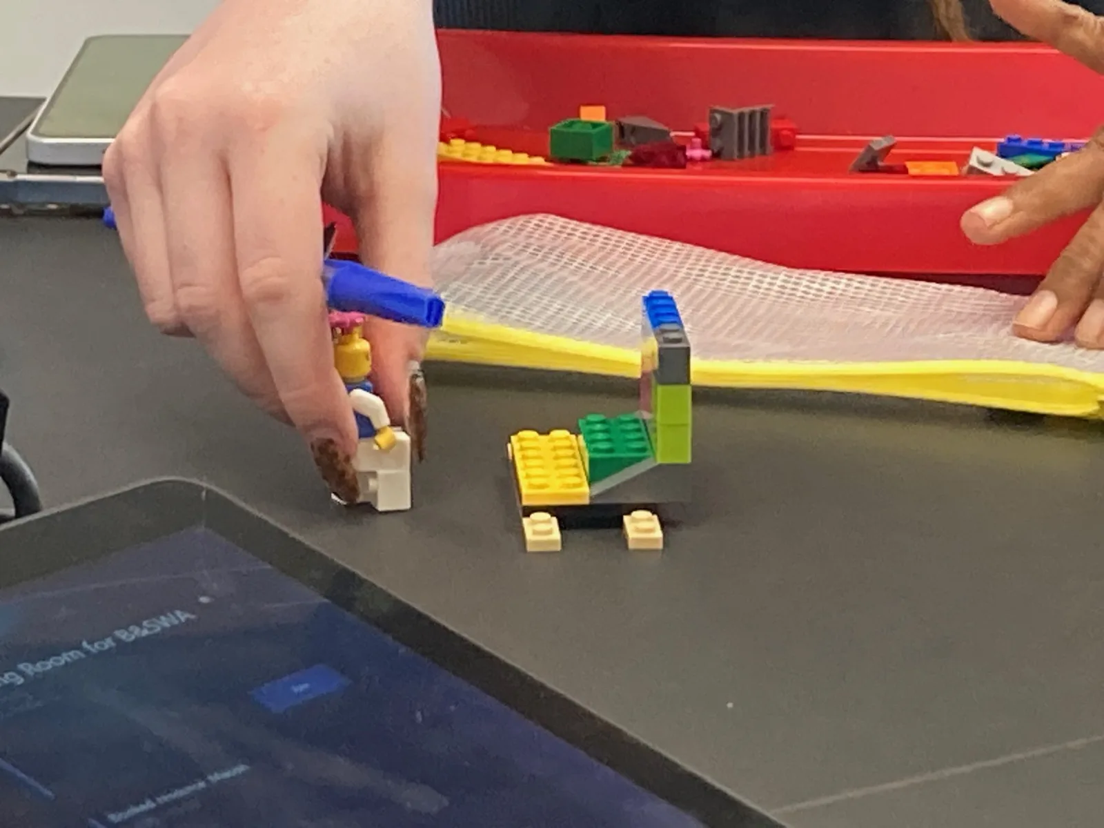 A participant explaining the meaning behind their LEGO® superpower model