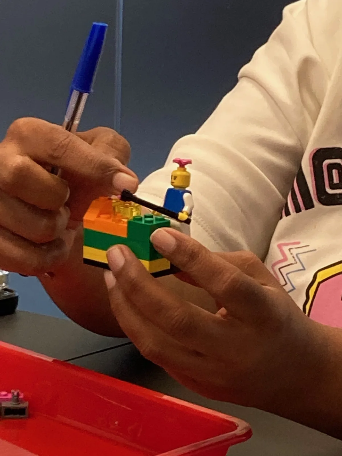 A workshop participant building a LEGO® model of their superpower
