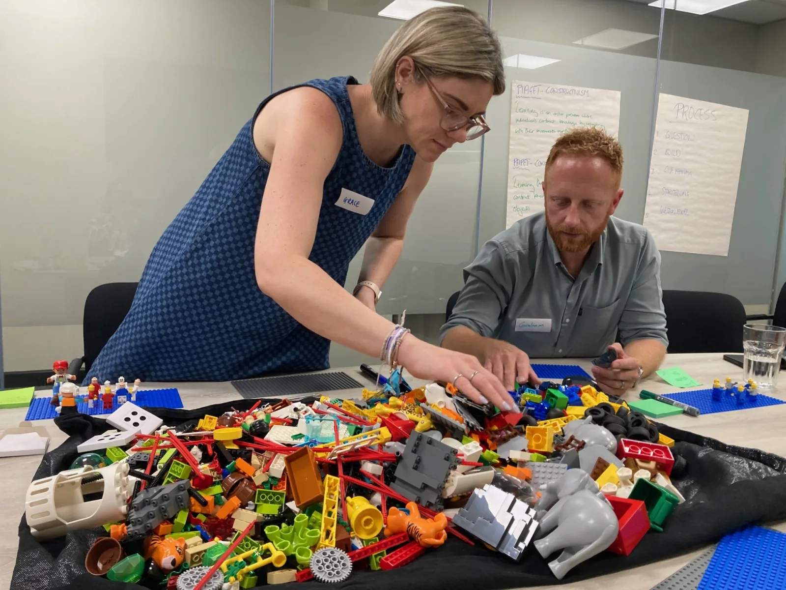 Insight Surveyors colleagues choosing LEGO® pieces during a workshop